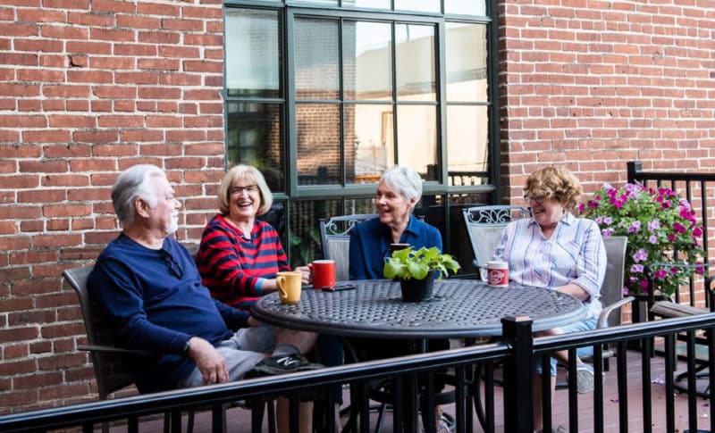 A group of friends having coffee on a patio.