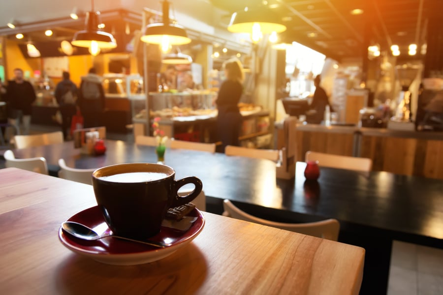 Coffee cup and saucer on a wooden table.