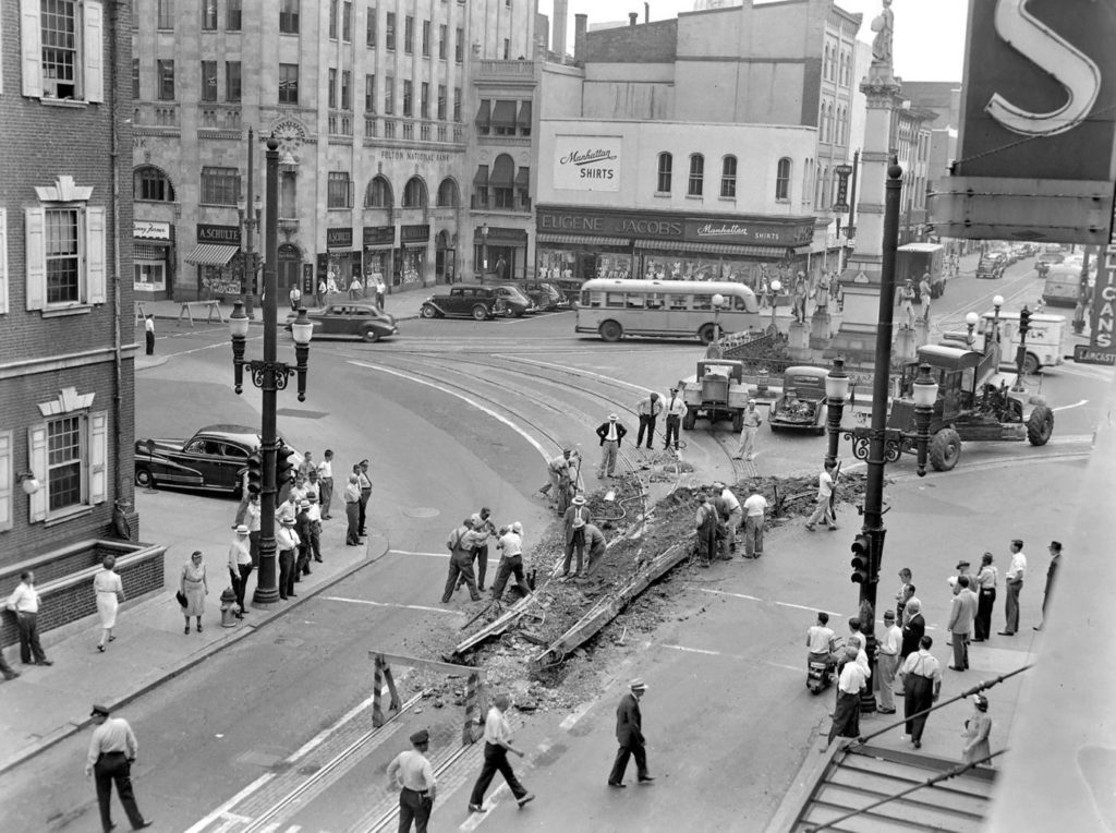 An old photo of a busy city intersection.