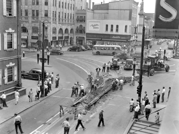 An old photo of a busy city intersection.