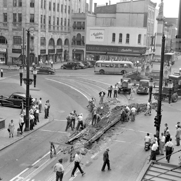 An old photo of a busy city intersection.