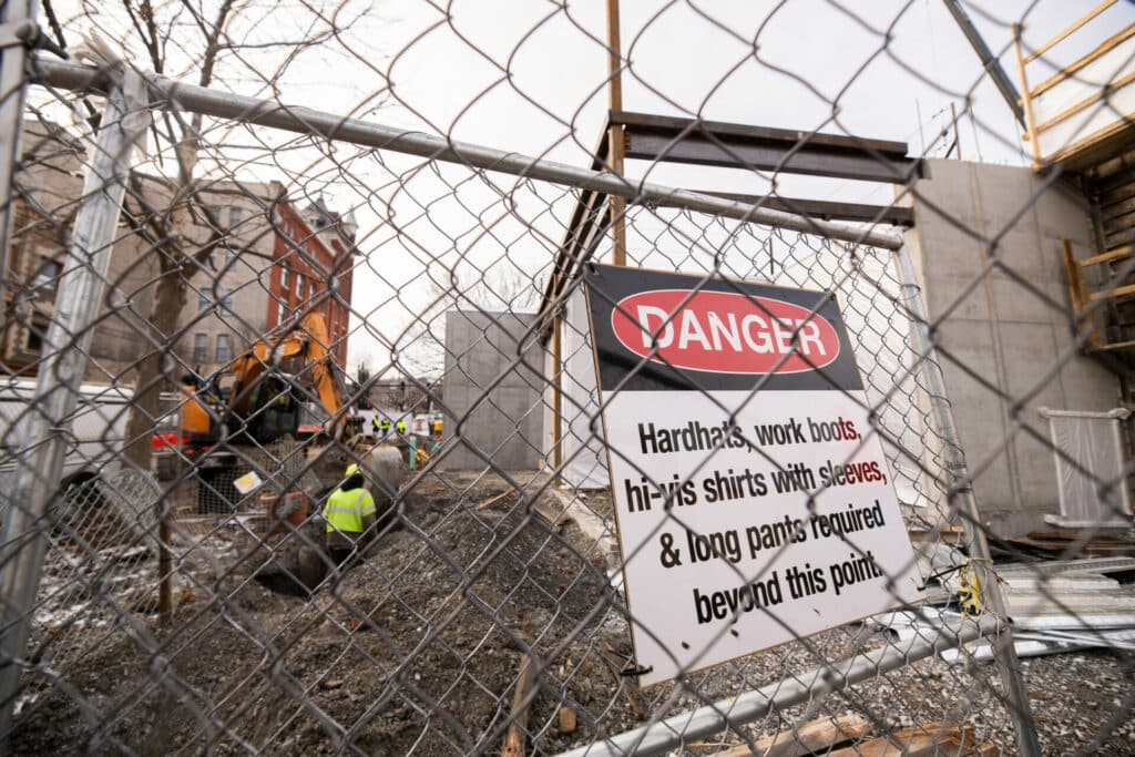 Construction danger sign on fence