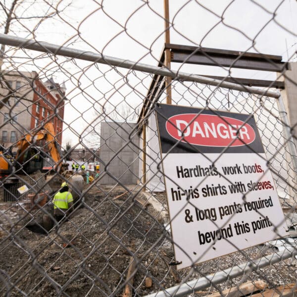 Construction danger sign on fence