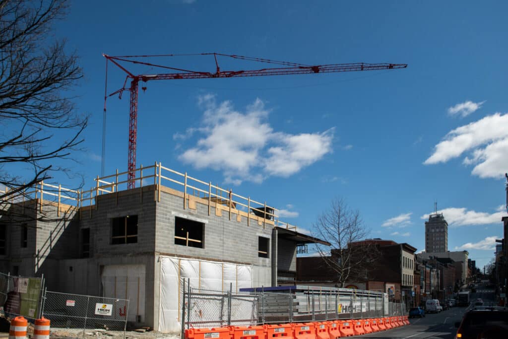 crane behind concrete wall