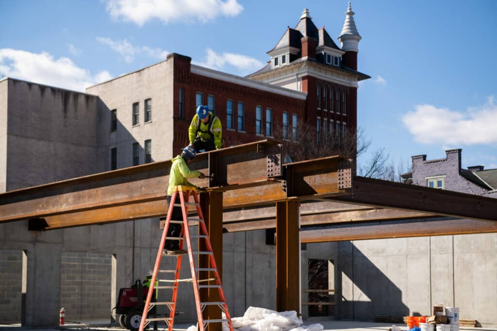 construction workers putting beams together