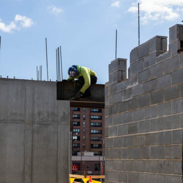 construction worker setting up a beam