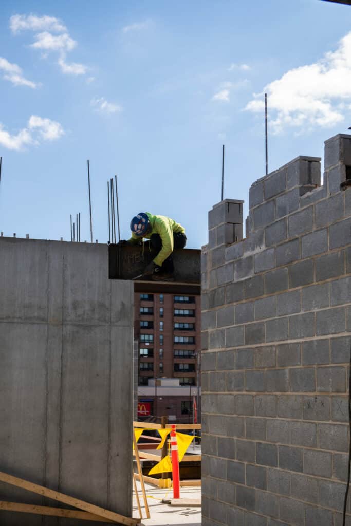 construction worker setting up a beam