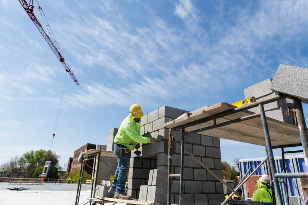 male laying cement blocks