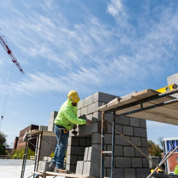 male laying cement blocks