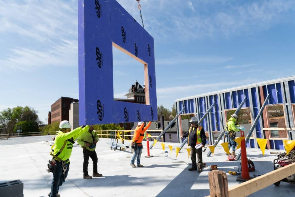 construction workers putting wall into place