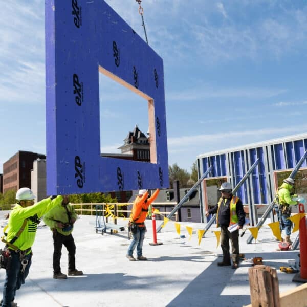 construction workers putting wall into place