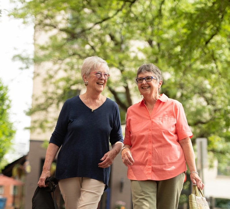 Two women smiling outside