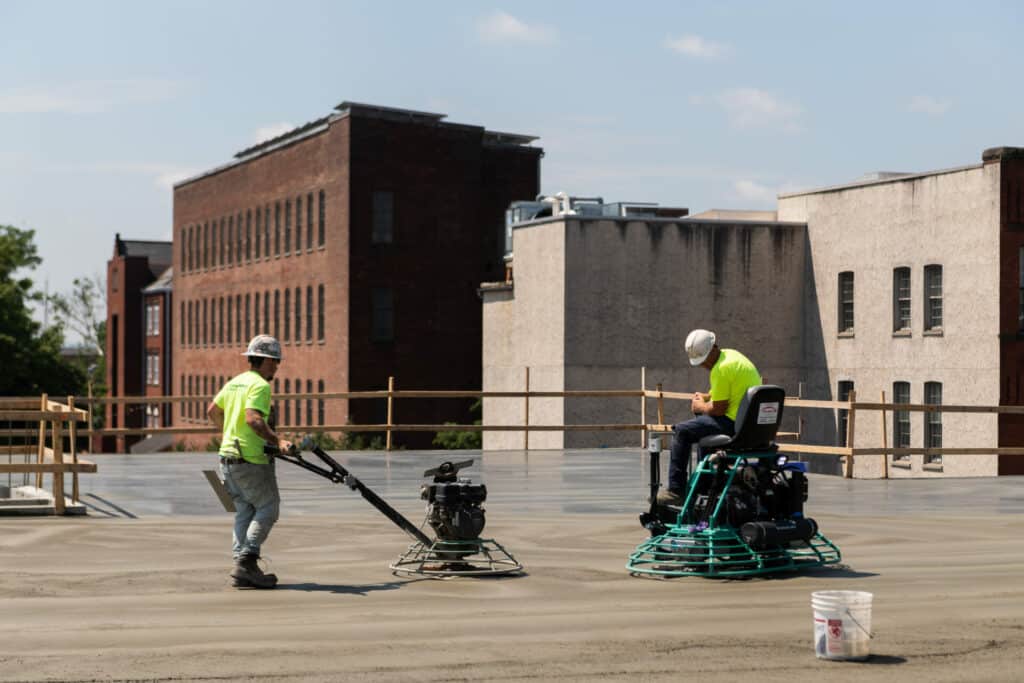 workers smoothing cement