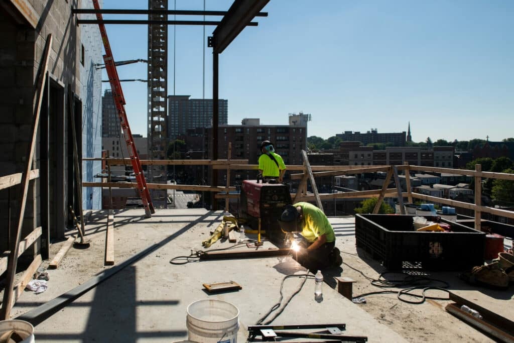 worker soldering beams together