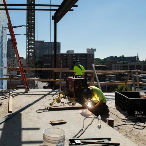 worker soldering beams together