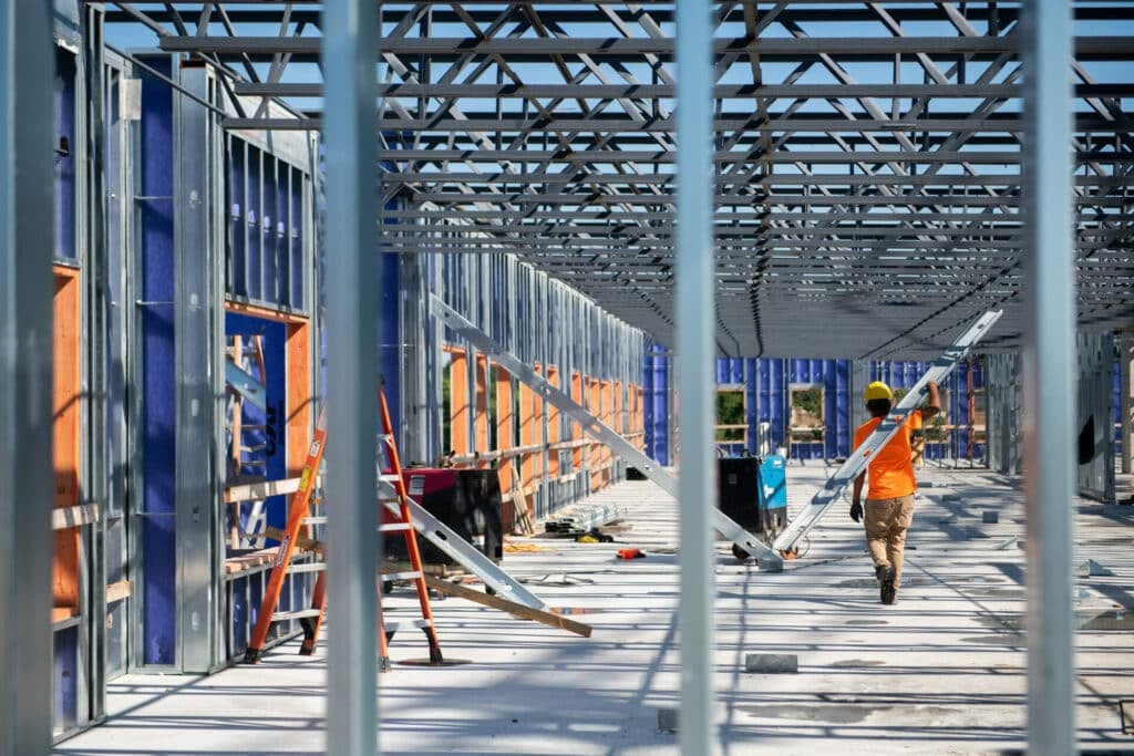 rows of beams and construction workers