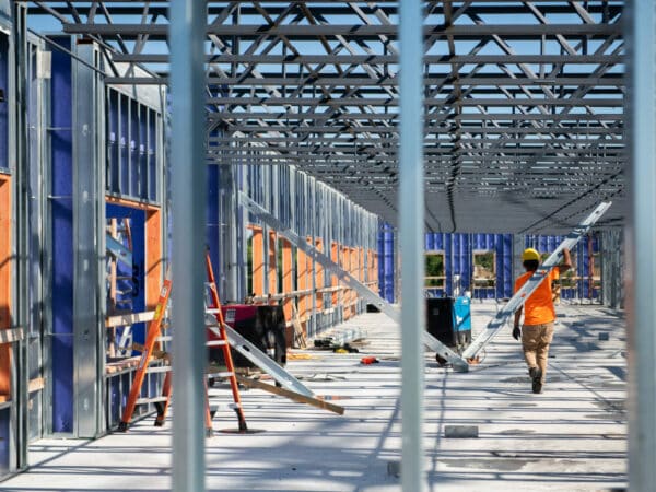 rows of beams and construction workers